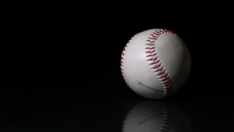 Baseball-spinning-on-black-surface