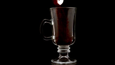 Coffee-granules-pouring-into-a-glass