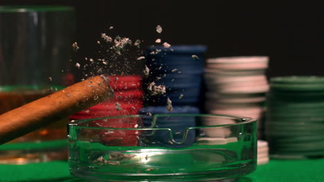 Cigar-tapping-ash-into-ash-tray-on-casino-table