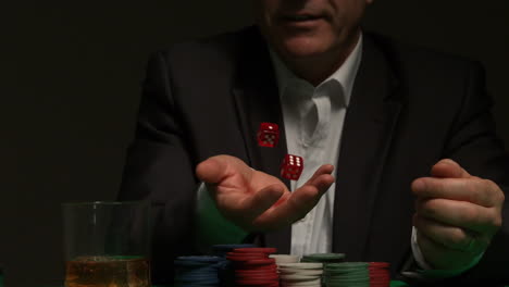 Cool-gambler-throwing-red-dice