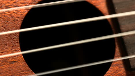 Hand-strumming-guitar-strings-close-up