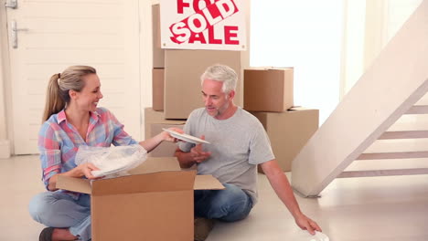 Couple-unpacking-cardboard-boxes
