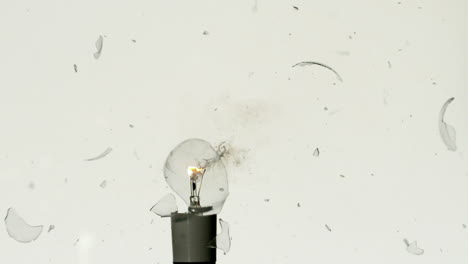 Arrow-shooting-through-light-bulb-on-white-background