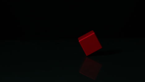 Bloque-Rojo-Girando-Sobre-Superficie-Negra