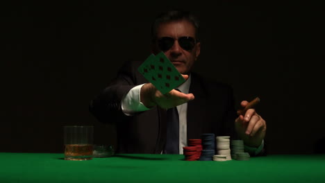 Cool-gambler-playing-poker-in-sunglasses
