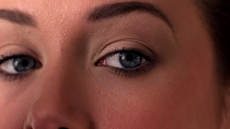 Close-up-of-woman-applying-eye-shadow-to-eye