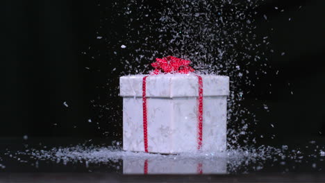 Glitter-falling-onto-christmas-present-in-slow-motion