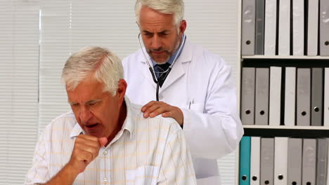 Doctor-examining-his-senior-patient-who-has-a-cough