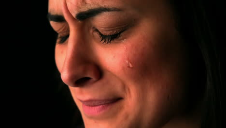 Upset-brunette-crying-on-black-background