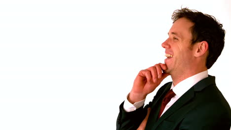 Happy-businessman-laughing-with-hand-on-chin