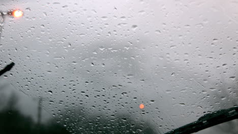 Windscreen-wiper-wiping-rain-away-from-car-window