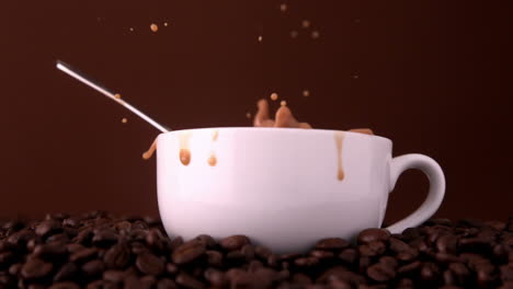 Teaspoon-falling-into-white-coffee-cup
