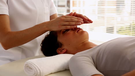 Woman-getting-reiki-therapy