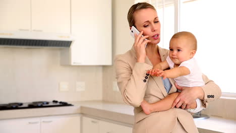 Geschäftsfrau-Hält-Baby-Beim-Telefonieren
