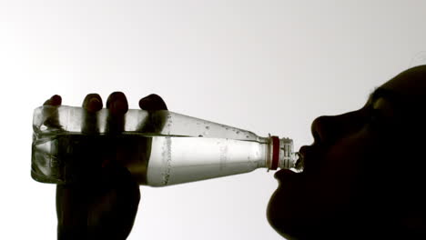 Silhouette-of-woman-drinking-from-bottle