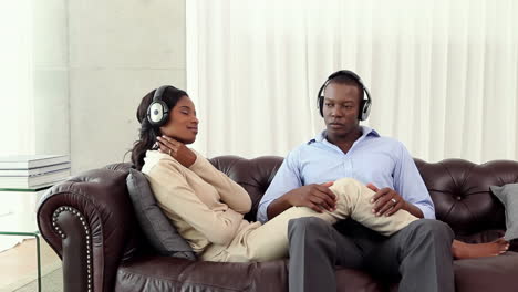 Couple-listening-to-music-on-the-couch-after-work