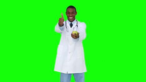 Happy-young-doctor-showing-camera-an-apple