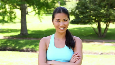 Fit-asian-girl-smiling-at-camera-with-arms-crossed