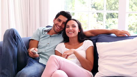 Attractive-couple-watching-tv-on-the-couch