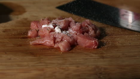 Pieces-of-pork-being-seasoned-with-salt