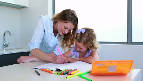 Smiling-mother-and-daughter-drawing-at-the-table
