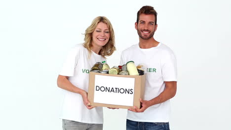 Two-volunteers-holding-a-donations-box