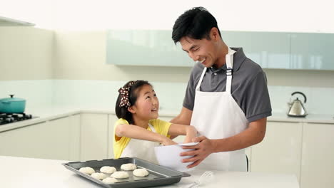Father-and-daughter-making-cookies-together