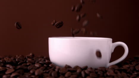 Coffee-beans-falling-into-white-cup