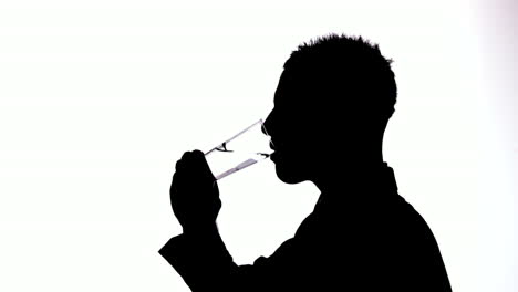 Silhouette-of-businessman-drinking-water-on-white-background