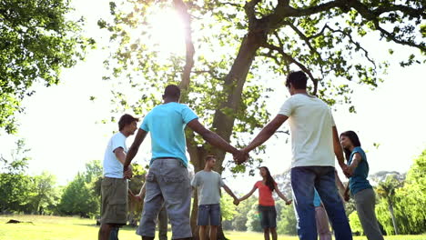 Young-people-holding-hands-in-a-circle