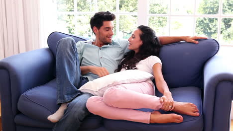 Attractive-couple-chatting-on-the-couch