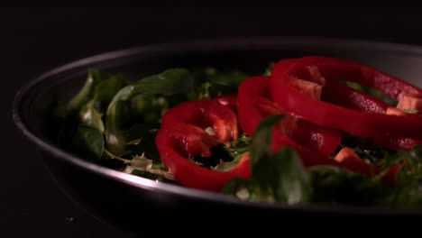 Red-pepper-slices-falling-on-lettuce