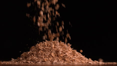 Cereal-flakes-pouring-on-black-background