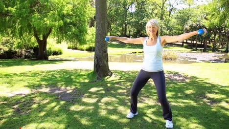 Blonde-woman-lifting-dumbbells-in-the-park