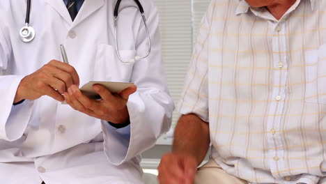 Doctor-shaking-hands-with-his-patient-and-giving-his-a-prescription