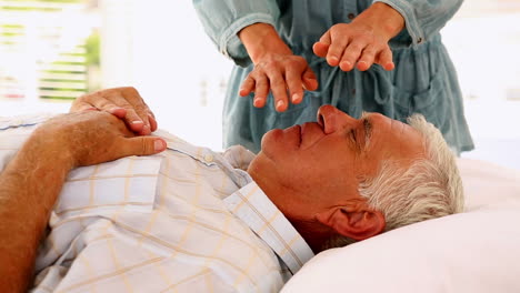 Senior-man-getting-reiki-therapy