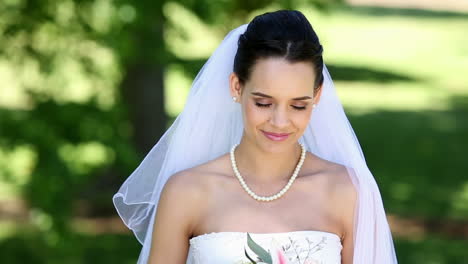Beautiful-bride-smiling-at-camera-in-the-park
