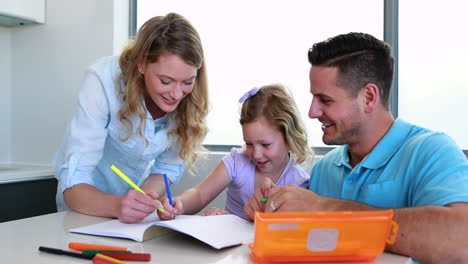 Smiling-parents-and-daughter-drawing-at-the-table