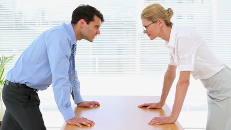 Business-people-having-a-stand-off-at-their-desk