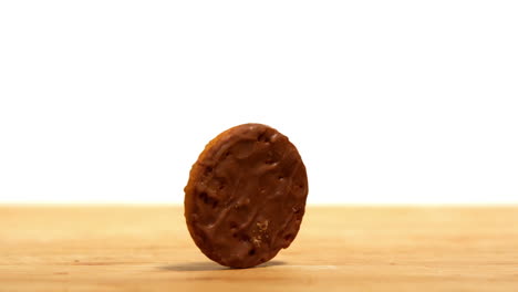 Biscuit-spinning-on-wooden-table