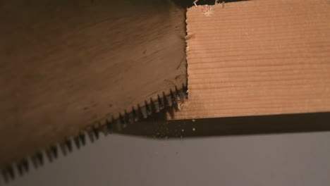 Saw-cutting-through-wood-close-up