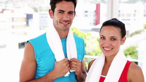 Fit-couple-smiling-at-camera