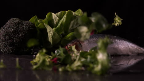 Lettuce-leaves-falling-in-front-of-fresh-trout