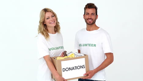 Two-volunteers-holding-a-donations-box