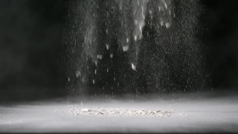 Flour-sprinkling-onto-black-surface