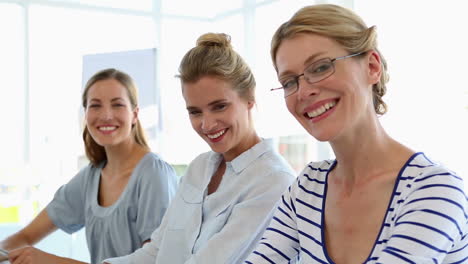 Businesswomen-smiling-at-camera-together