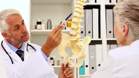 Doctor-explaining-a-spine-model-to-patient