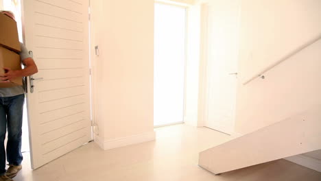 Man-carrying-boxes-walking-into-his-new-home