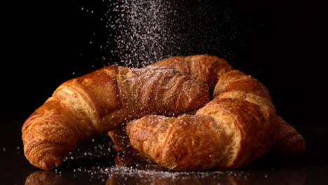 Powdered-sugar-sprinkling-onto-croissants