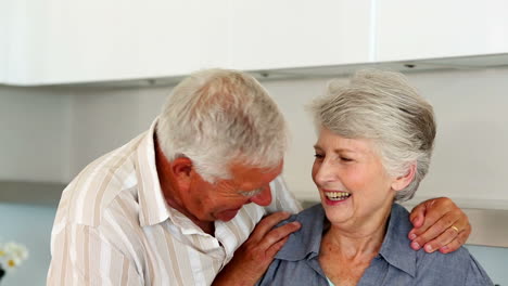 Senior-couple-smiling-at-the-camera-together